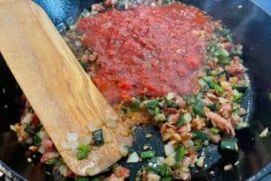 fire roasted crushed tomatoes added to the skillet with the cooked veggies and bacon