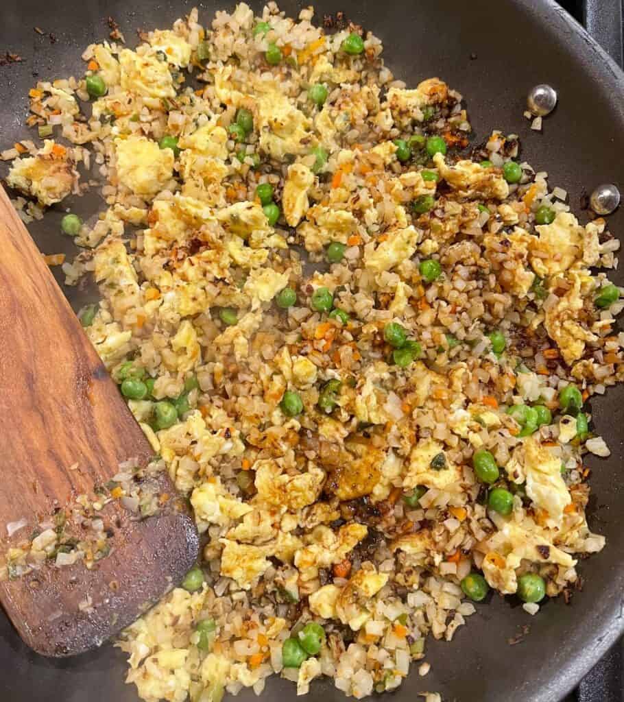 adding Japanese BBQ sauce to cauliflower egg fried rice 