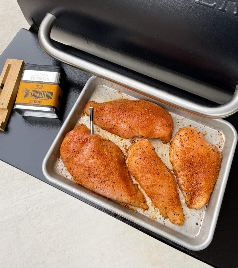 chicken breasts seasoned with Traeger chicken rub and a Meater meat thermometer inside