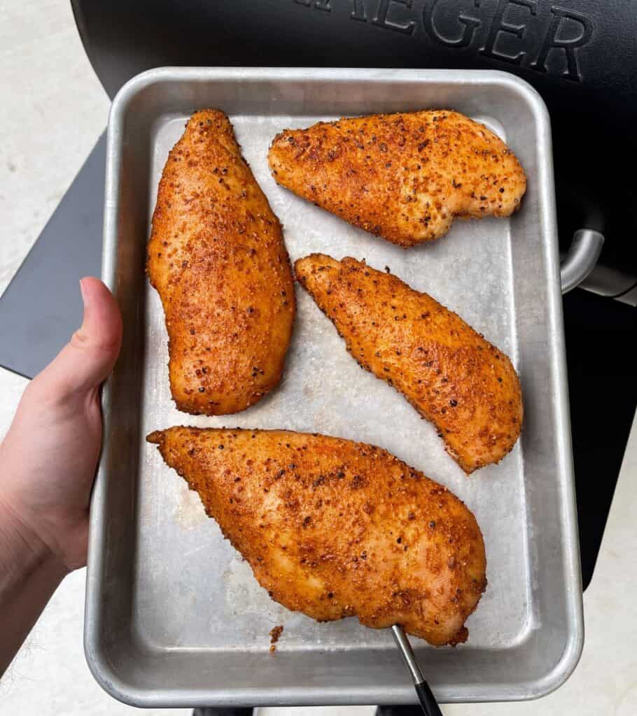 four smoked chicken breasts on a quarter sheet pan 