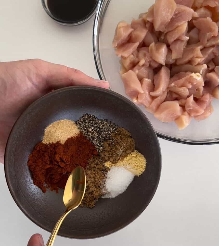 bbq rub in a bowl before seasoning diced chicken breast