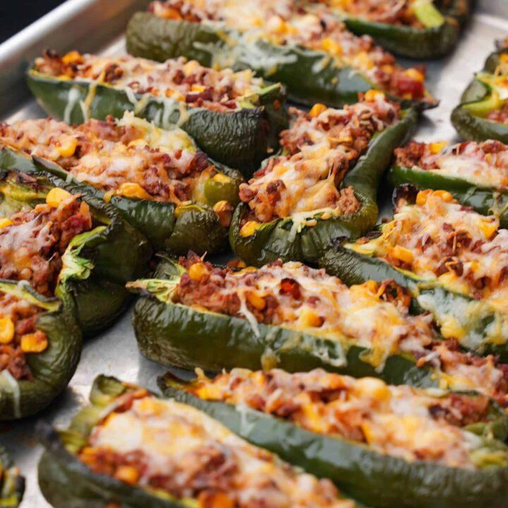 sheet pan with stuffed poblano peppers coming off the Traeger grill