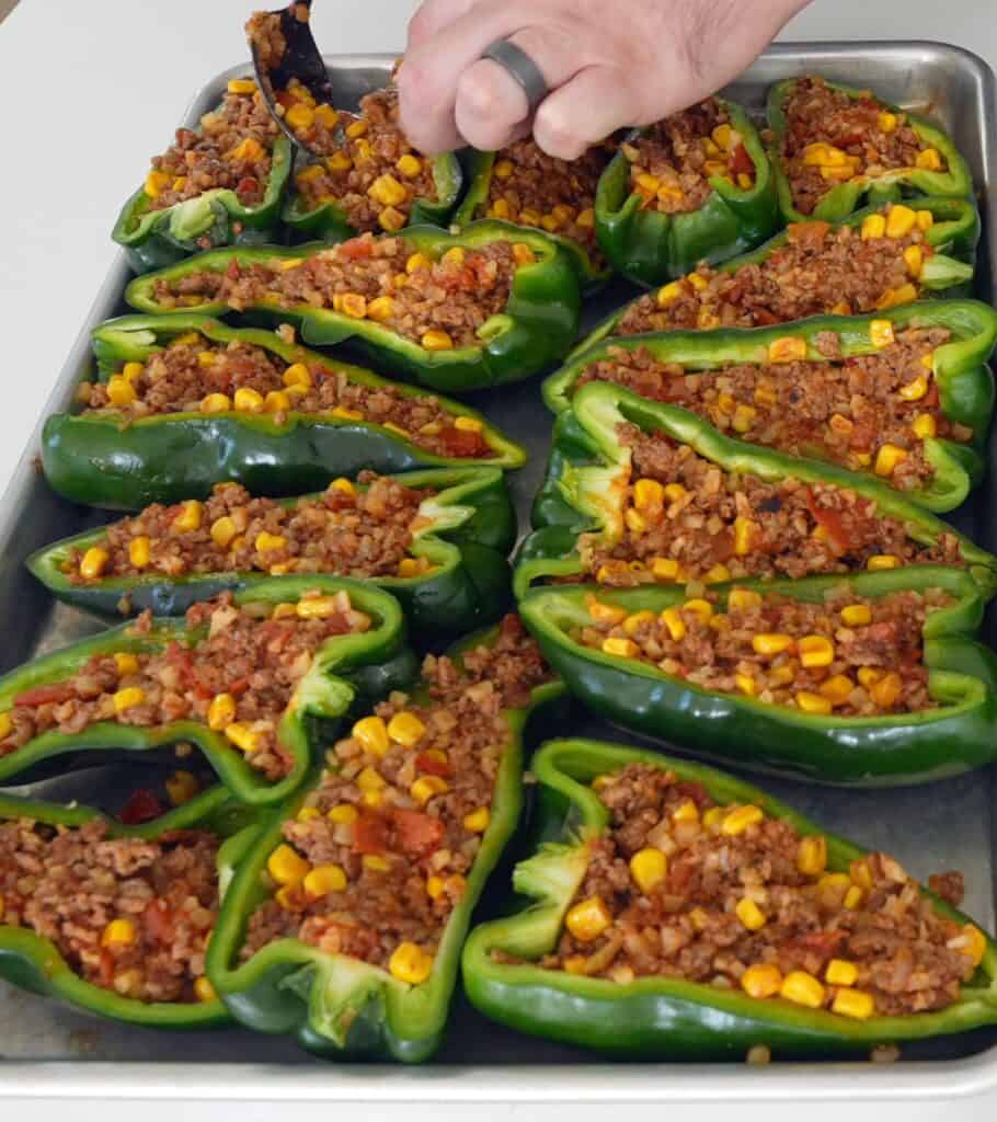 stuffed poblano peppers on a sheet pan before smoking