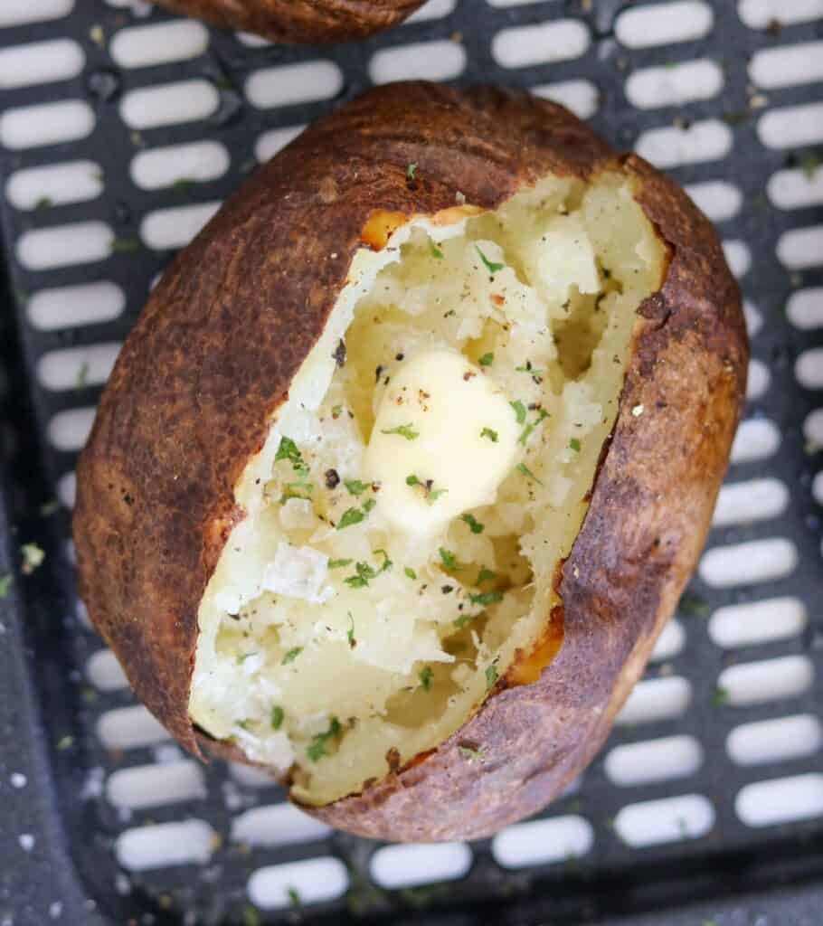 baked potato with butter, salt, pepper, and parsley