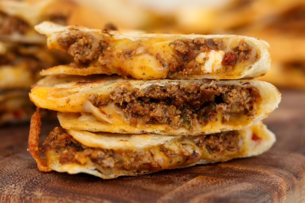 sliced and stacked cheesy ground beef quesadilla
