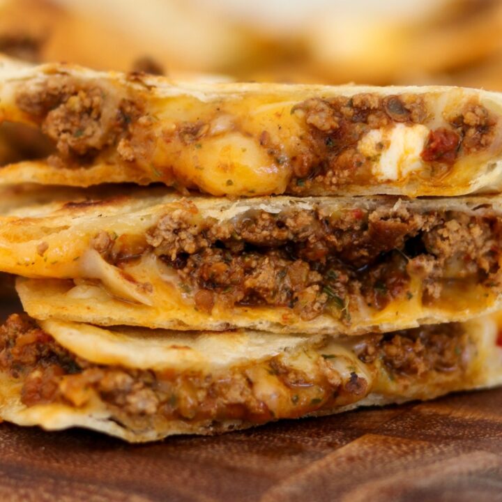sliced and stacked cheesy ground beef quesadilla