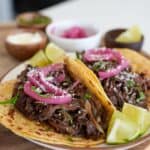 pulled beef tacos with pickled onion, cotija cheese, and cilantro