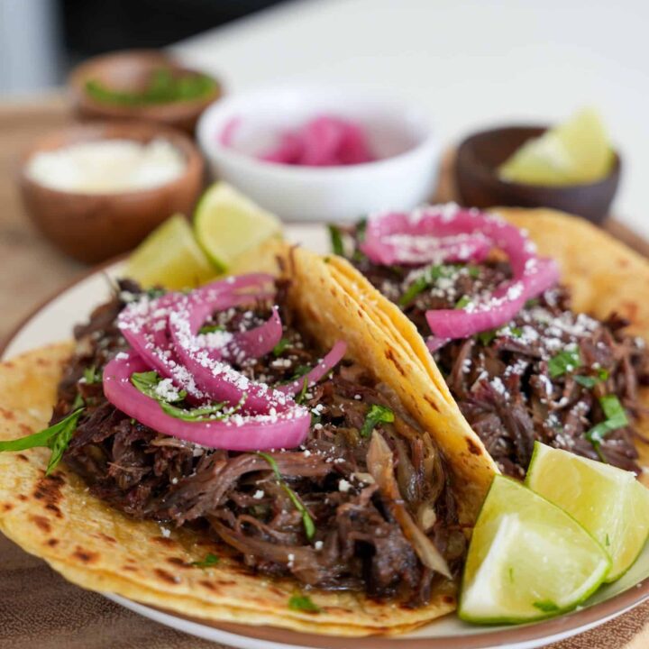 pulled beef tacos with pickled onion, cotija cheese, and cilantro