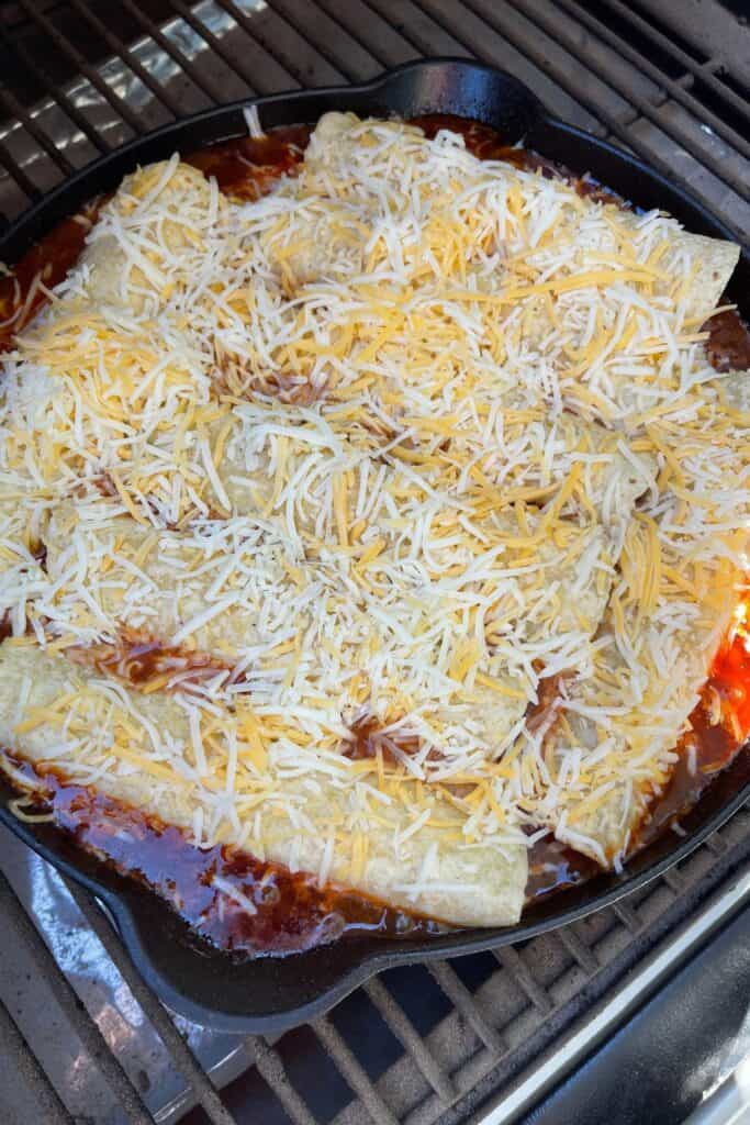 shredded Mexican cheese on top of the enchiladas