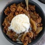 bowl of smoked apple crisp topped with vanilla ice cream