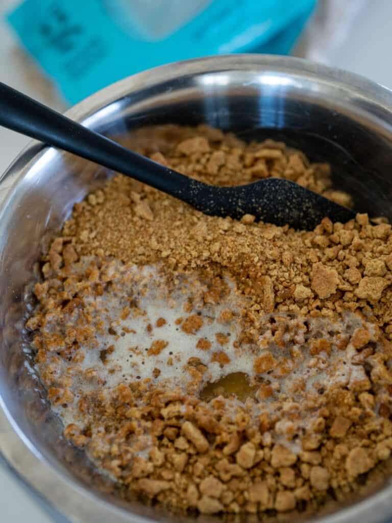 Graham cracker crumble ingredients being mixed together.