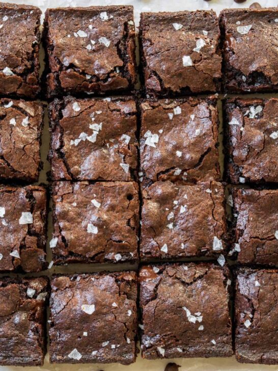 tray of espresso brownies sliced into small squares with sea salt on top