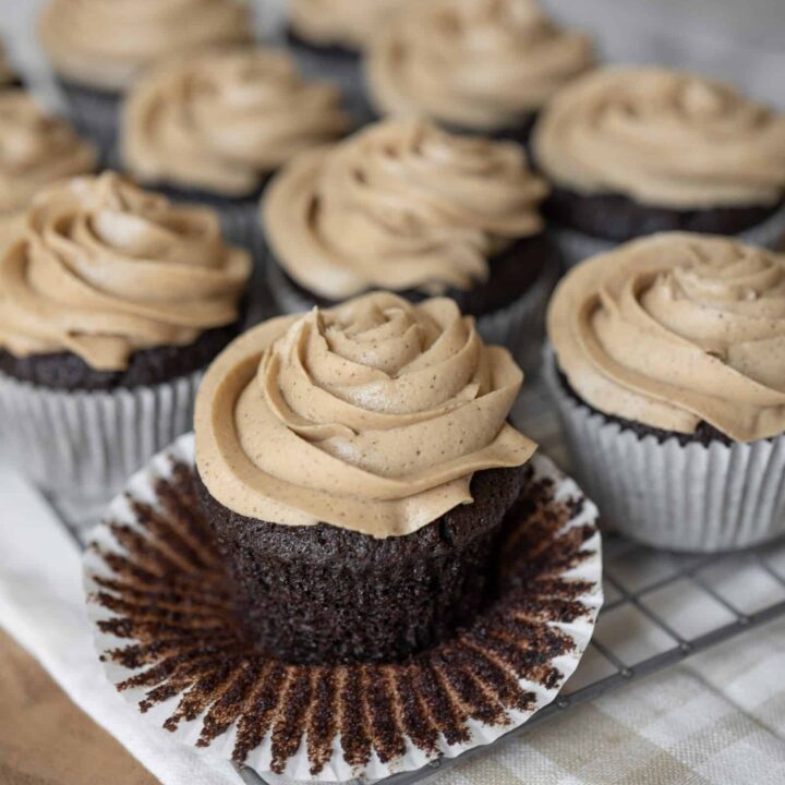 Espresso cupcakes with one cupcake's liner pulled down.