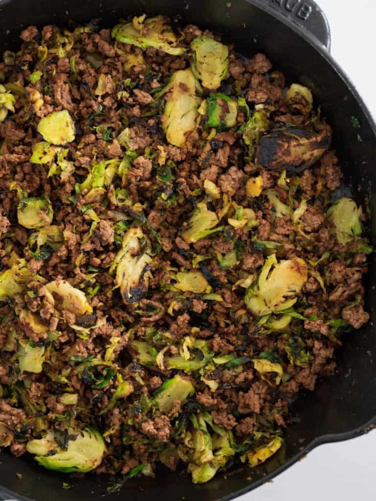 finished Tex Mex ground beef and brussels sprouts in a cast iron skillet before serving