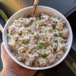 wooden spoon in a bowl of potato salad in front of Traeger pellet smoker