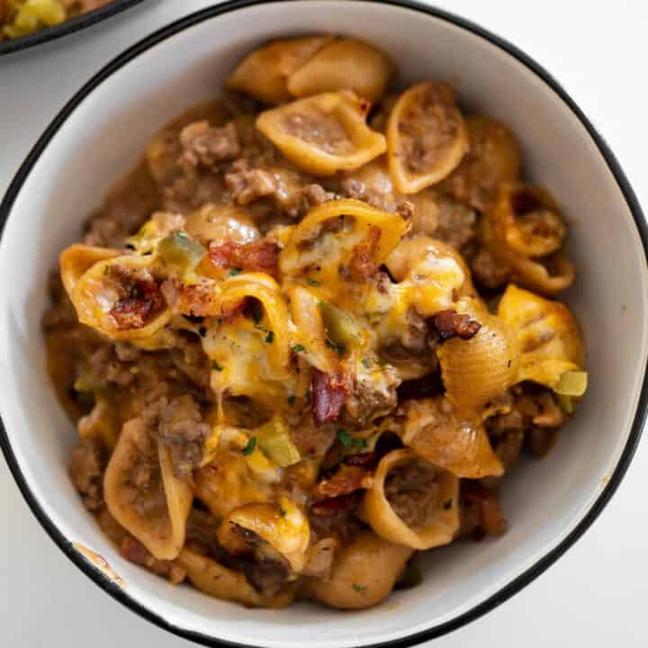 ground beef and bacon cheeseburger pasta in a white bowl
