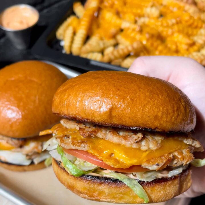 two chicken burgers with cheese fries
