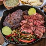 ingredients for Traeger ribeye steak tacos in a cast iron skillet on the Traeger ironwood shelf