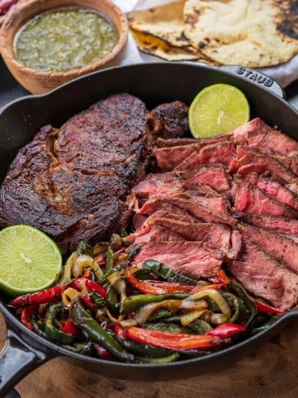 ingredients for Traeger ribeye steak tacos in a cast iron skillet on the Traeger ironwood shelf