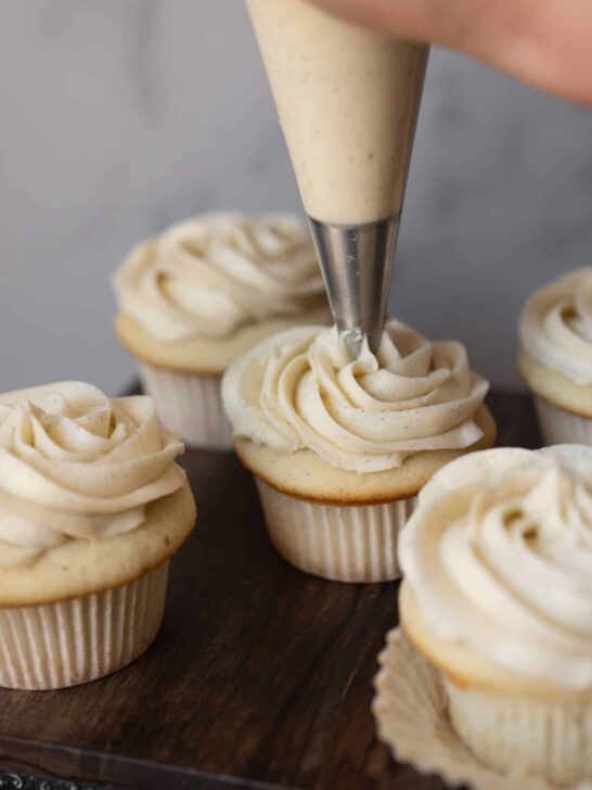 Vanilla bean buttercream being piped onto a cupcake.
