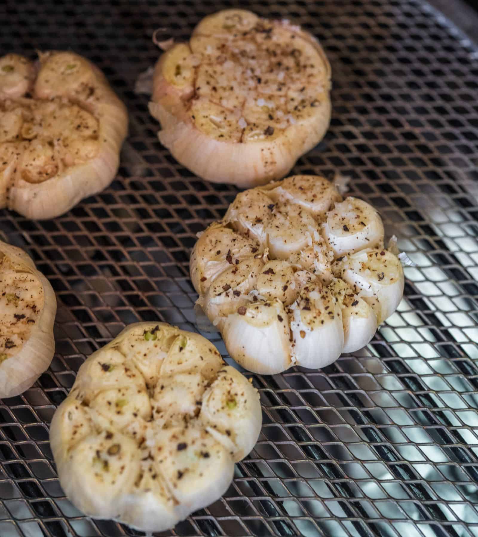 Traeger smoked garlic cloves in a white bowl