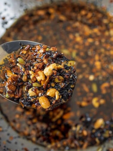 Mexican chili crisp on a spoon in a large mixing bowl