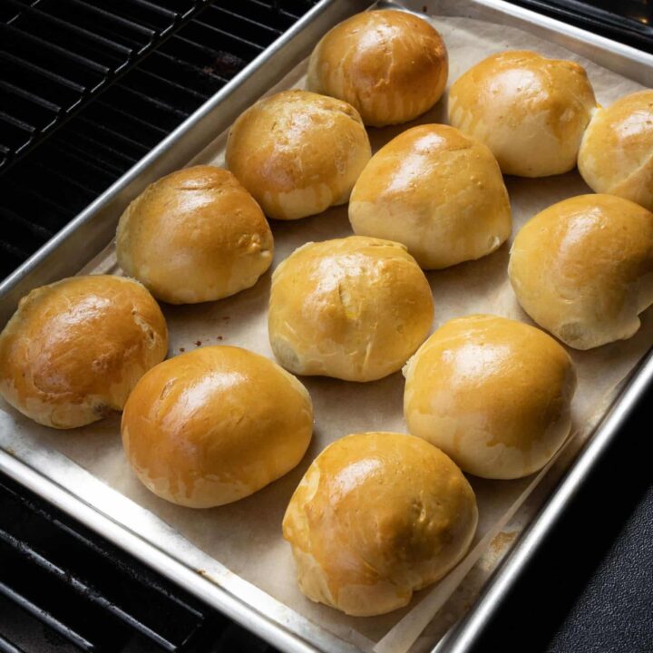 baked kolaches on a sheet pan inside a Traeger grill